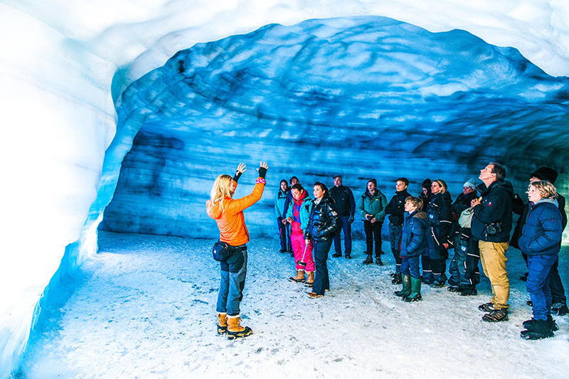 tour guide in ice cave with tourists